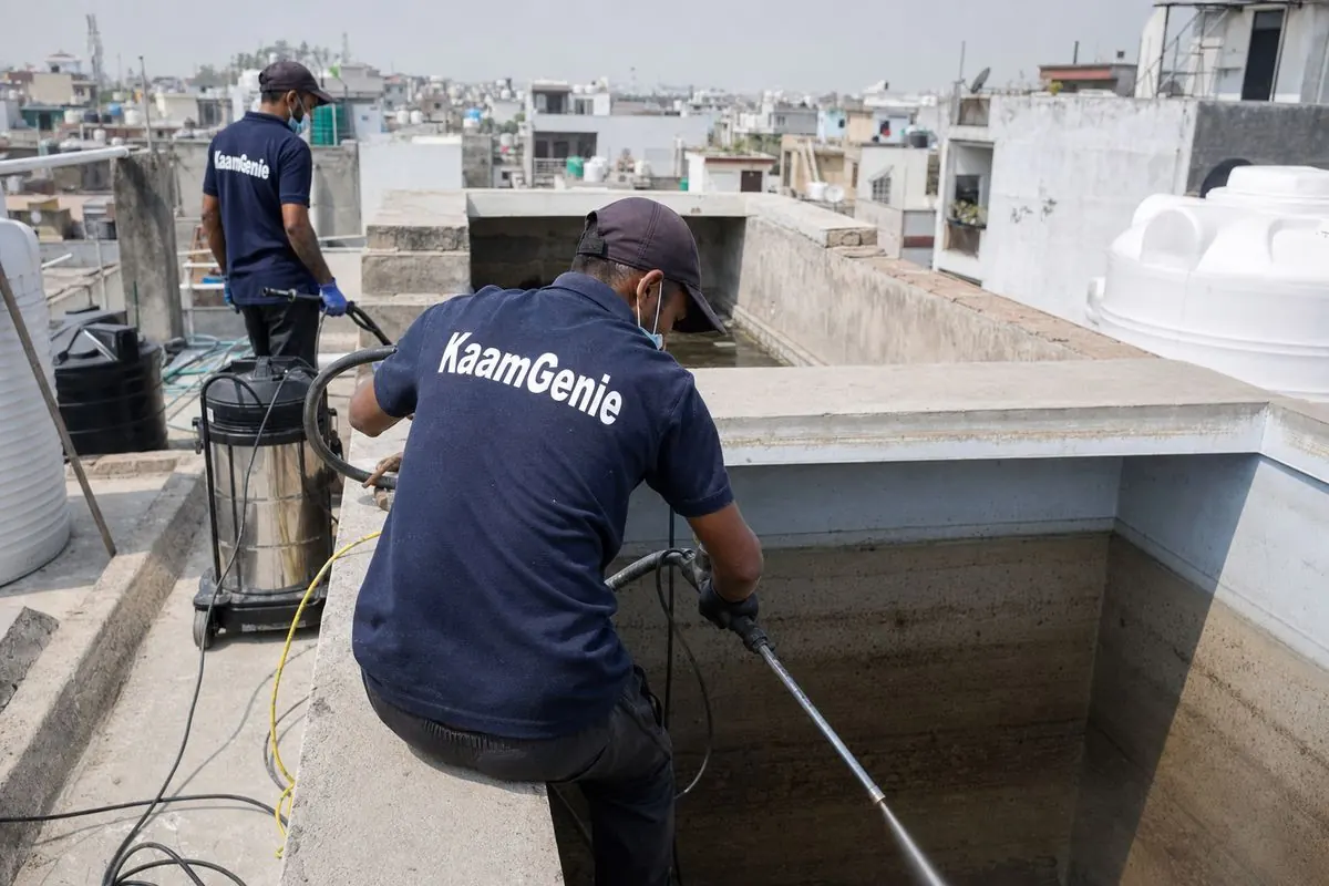 KaamGenie crew cleaning a overhead (rooftop) tank in Palam, Delhi