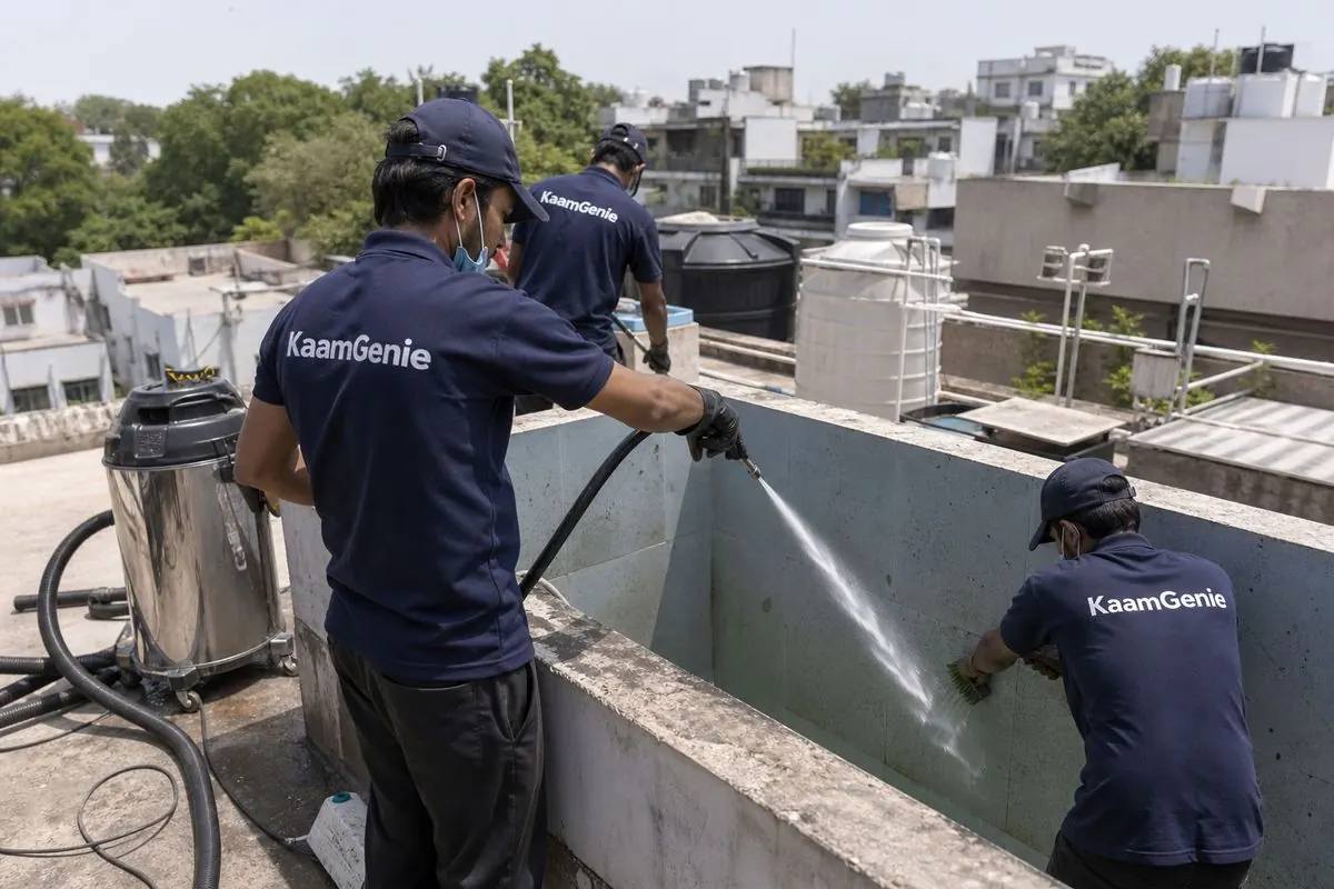 KaamGenie crew cleaning a overhead (rooftop) tank in Pamposh Enclave, Delhi