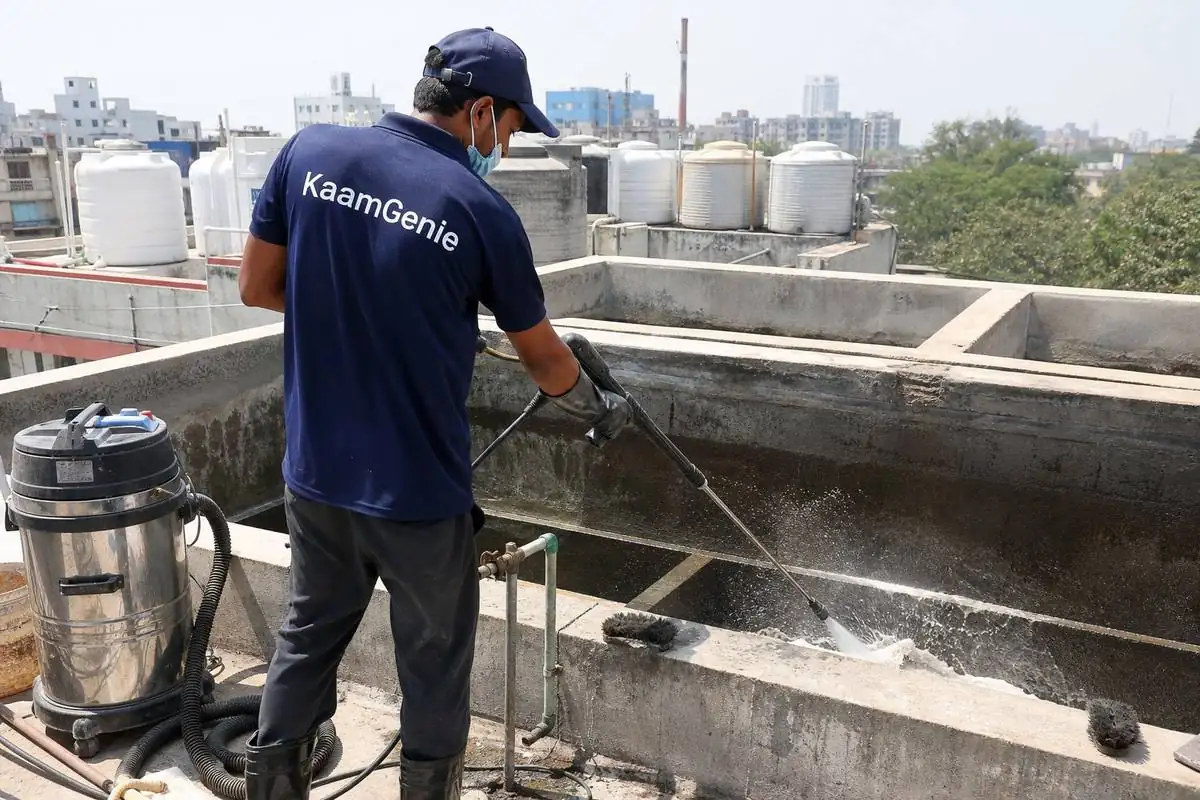 KaamGenie crew cleaning a overhead (rooftop) tank in Patparganj, Delhi