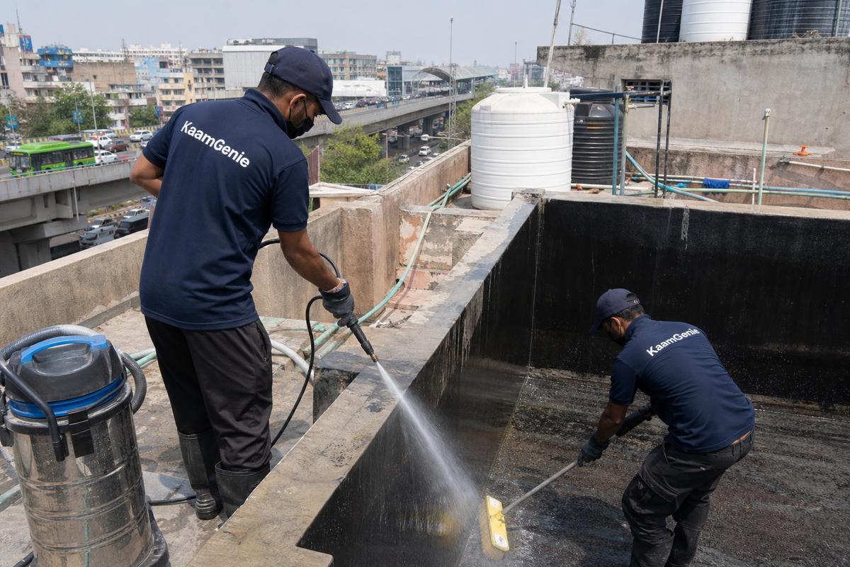 KaamGenie crew cleaning a overhead (rooftop) tank in Peeragarhi, Delhi