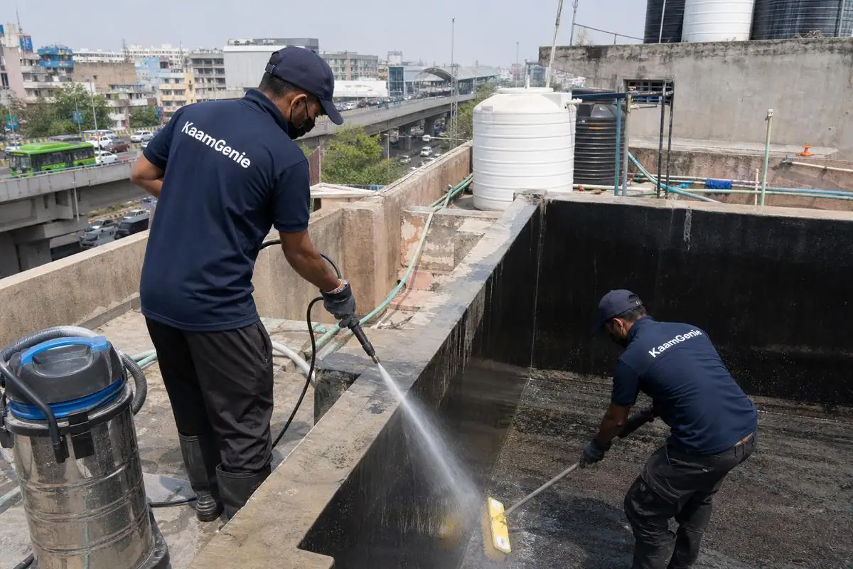 KaamGenie crew cleaning a overhead (rooftop) tank in Peeragarhi, Delhi