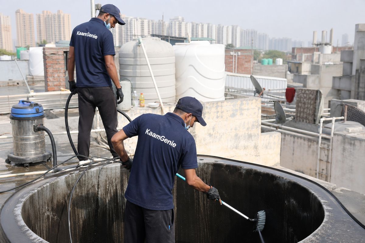 KaamGenie crew cleaning a overhead (rooftop) tank in Pooth Kalan, Delhi