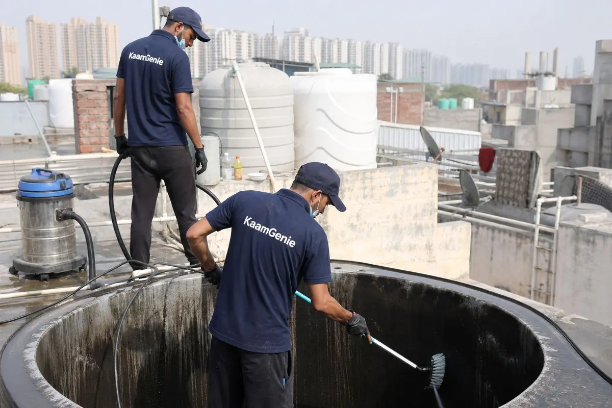 KaamGenie crew cleaning a overhead (rooftop) tank in Pooth Kalan, Delhi