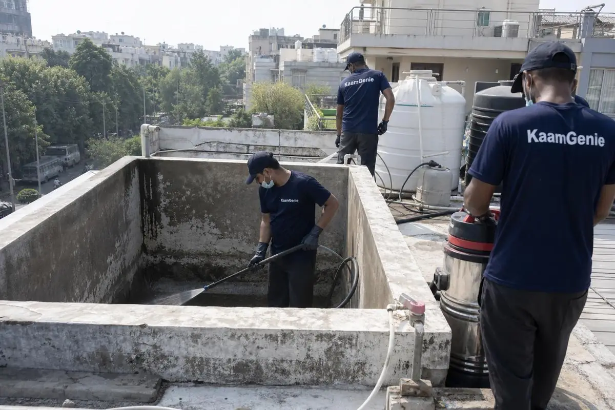 KaamGenie crew cleaning a overhead (rooftop) tank in Preet Vihar, Delhi