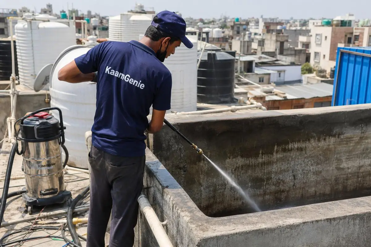 KaamGenie crew cleaning a overhead (rooftop) tank in Rajinder Nagar, Delhi