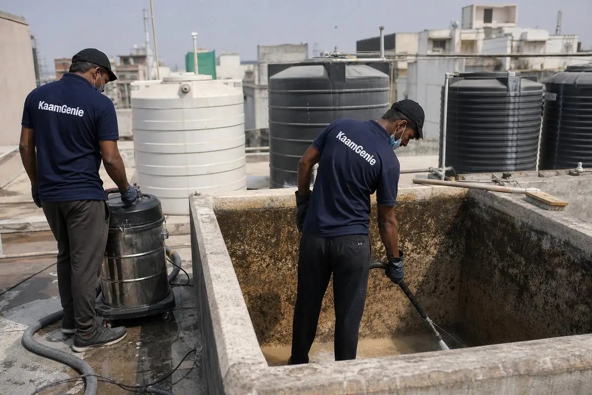 KaamGenie crew cleaning a overhead (rooftop) tank in Roop Nagar, Delhi