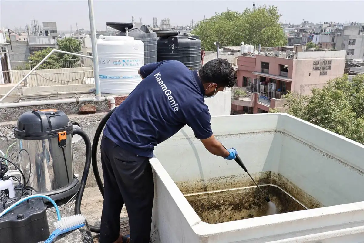 KaamGenie crew cleaning a overhead (rooftop) tank in Sadiq Nagar, Delhi