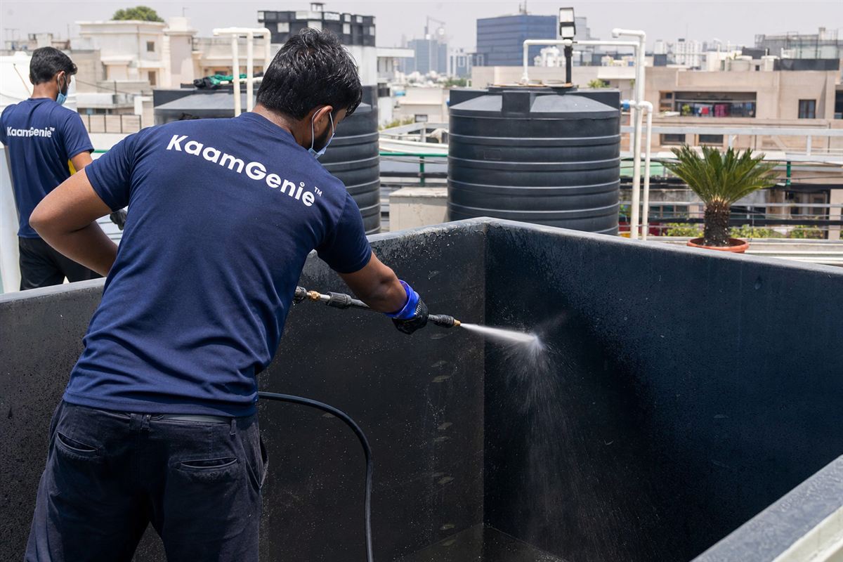 KaamGenie crew cleaning a overhead (rooftop) tank in Saket, Delhi