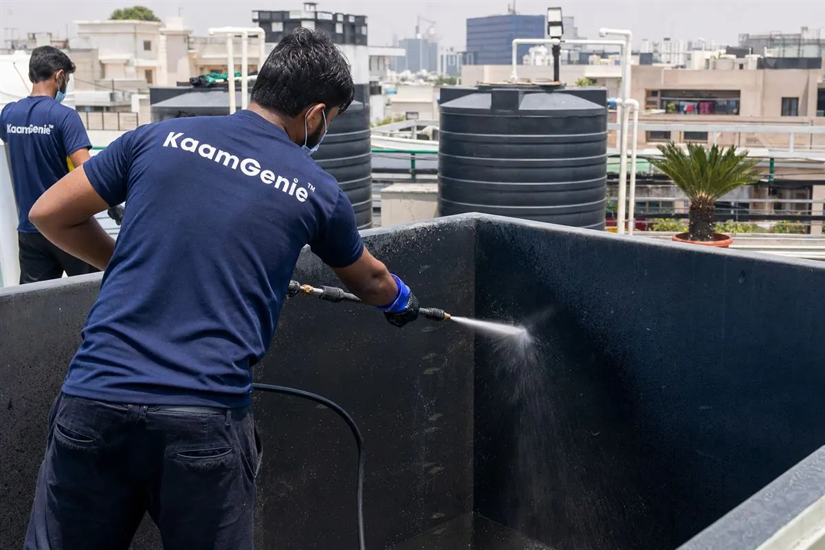 KaamGenie crew cleaning a overhead (rooftop) tank in Saket, Delhi