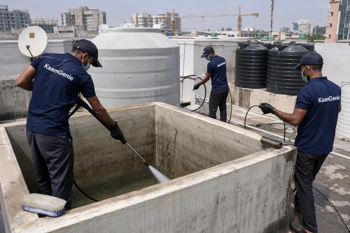 KaamGenie crew cleaning a overhead (rooftop) tank in Sarojini Nagar, Delhi