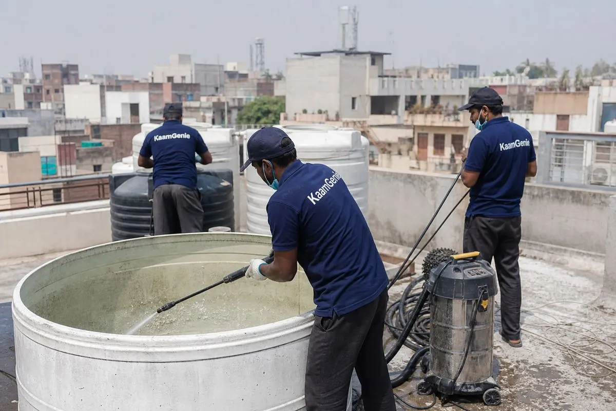KaamGenie crew cleaning a overhead (rooftop) tank in Satyawati Nagar, Delhi
