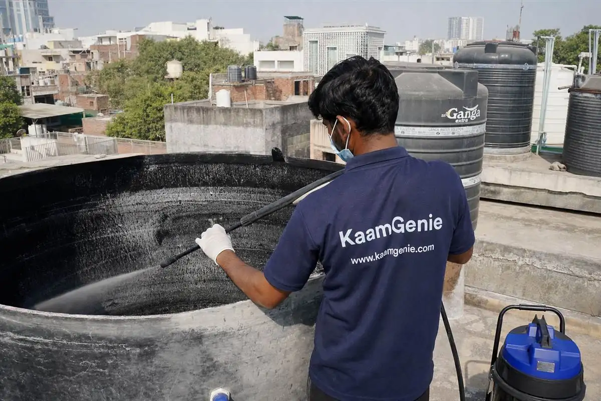 KaamGenie crew cleaning a overhead (rooftop) tank in Shahpur Jat, Delhi