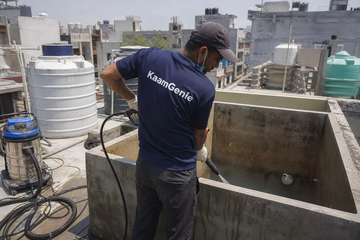 KaamGenie crew cleaning a overhead (rooftop) tank in Shiv Vihar, Delhi