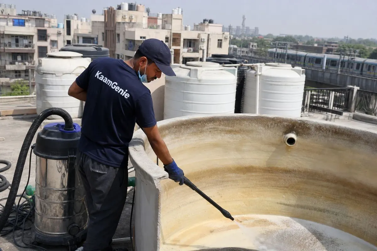KaamGenie crew cleaning a overhead (rooftop) tank in Shivaji Park, Delhi