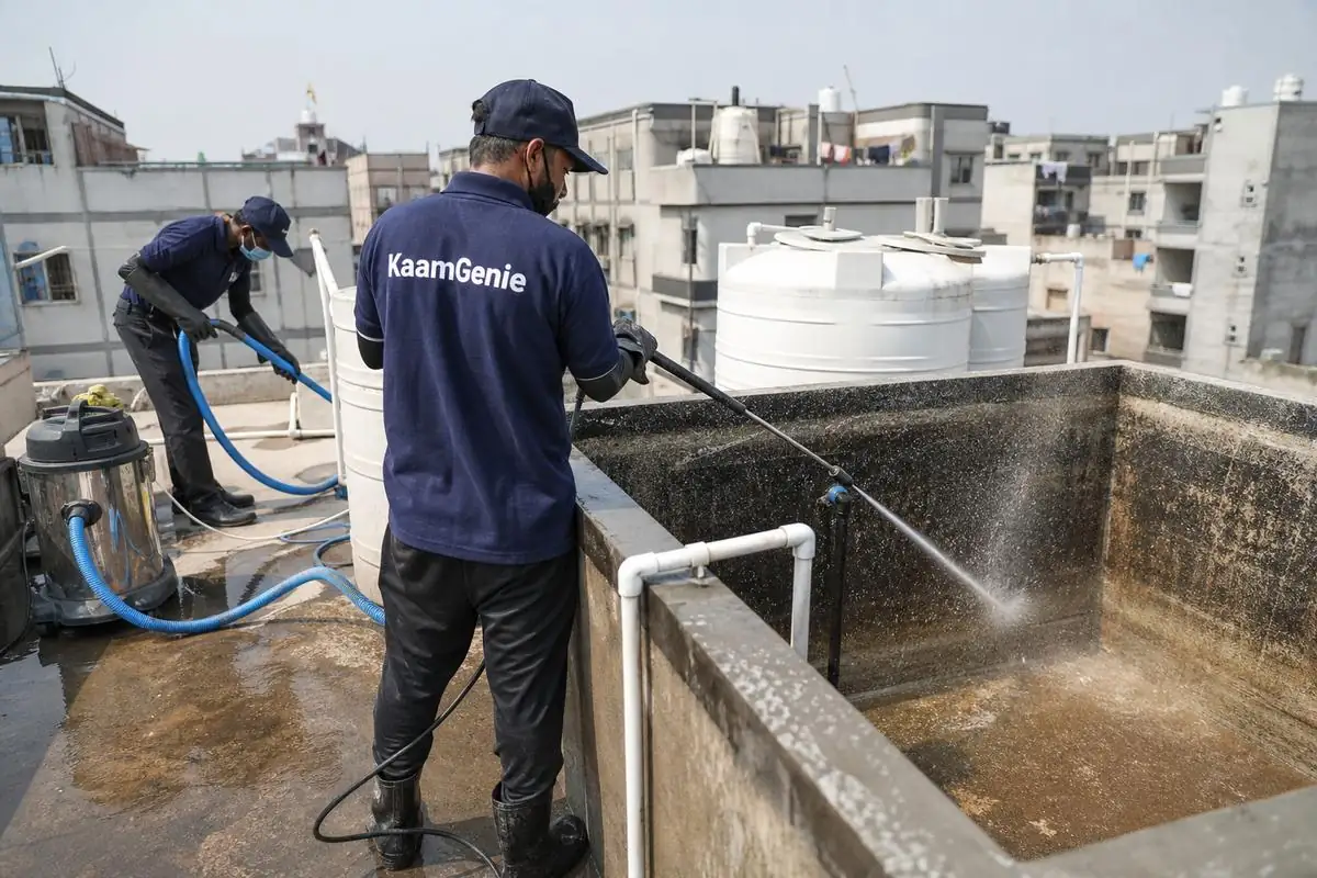 KaamGenie crew cleaning a overhead (rooftop) tank in Sultanpuri, Delhi