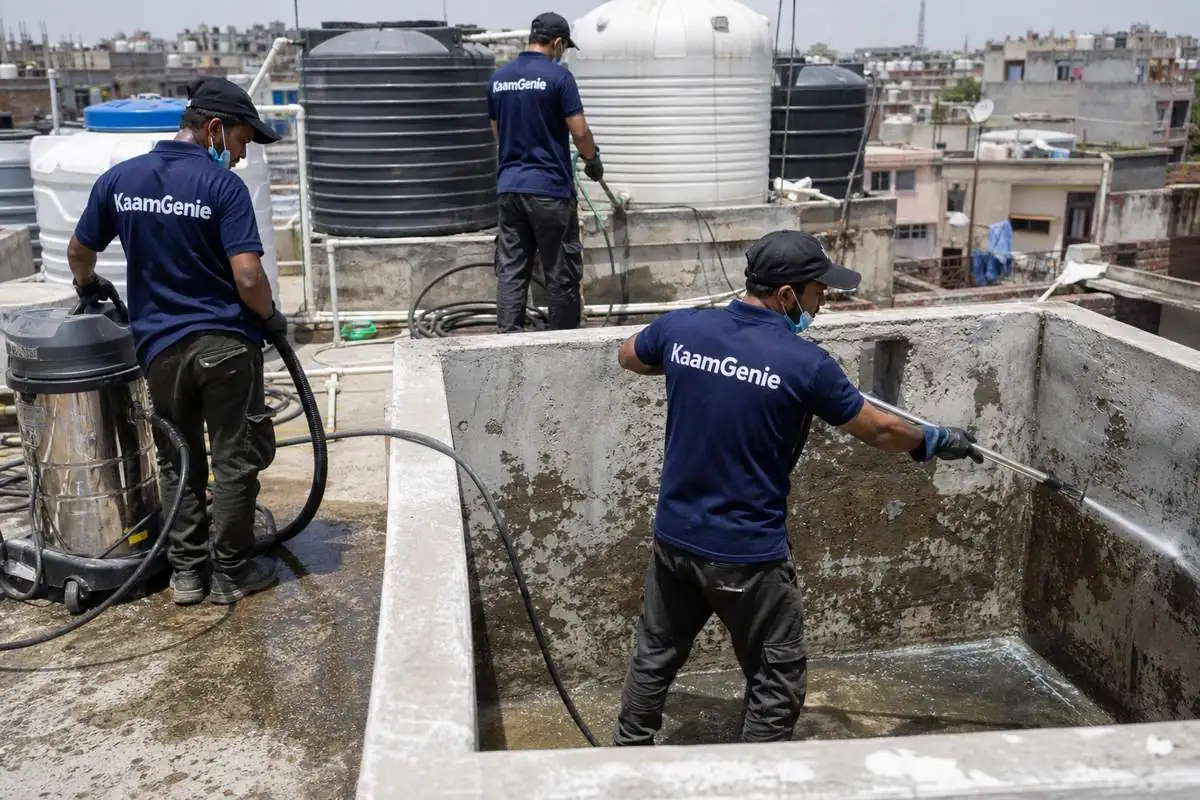 KaamGenie crew cleaning a overhead (rooftop) tank in Sunder Nagari, Delhi