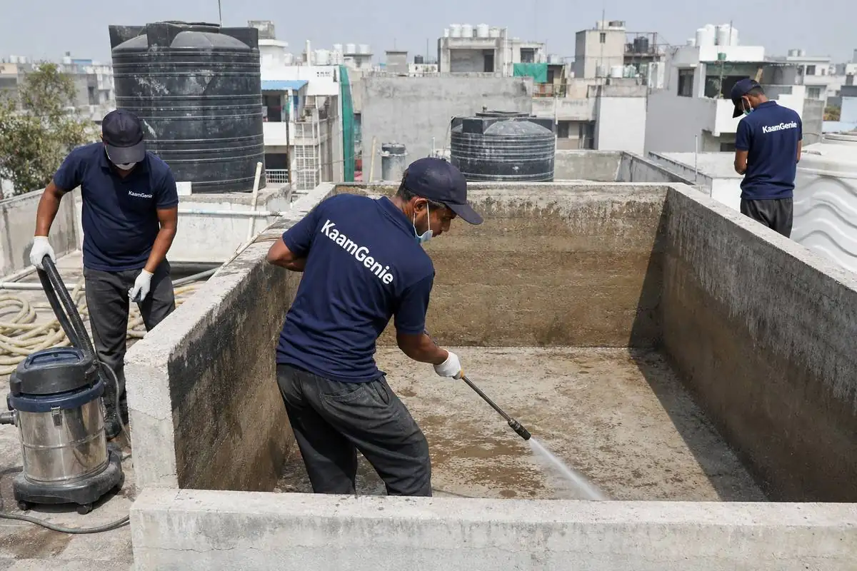 KaamGenie crew cleaning a overhead (rooftop) tank in Surajmal Vihar, Delhi