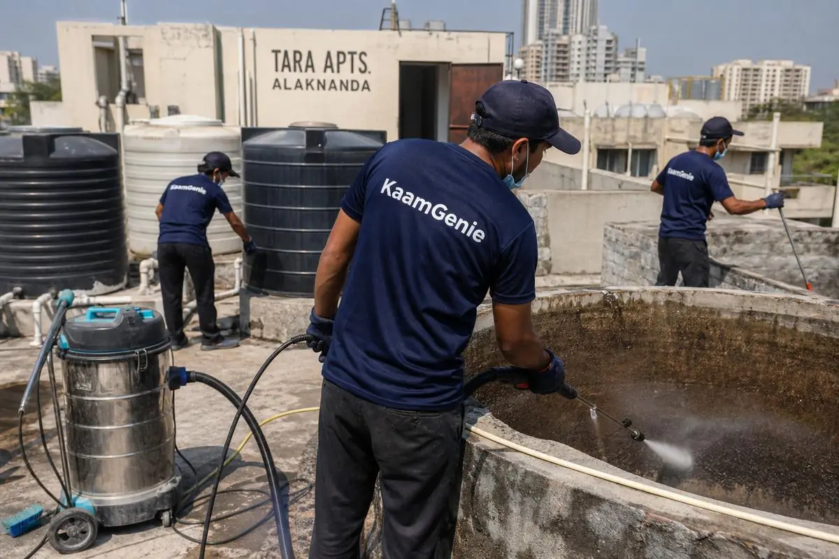 KaamGenie crew cleaning a overhead (rooftop) tank in Tara Apartments, Delhi