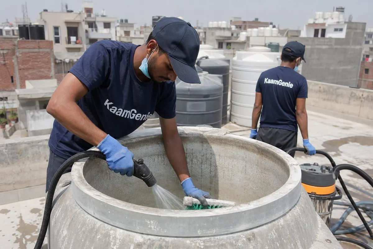 KaamGenie crew cleaning a overhead (rooftop) tank in Timarpur, Delhi