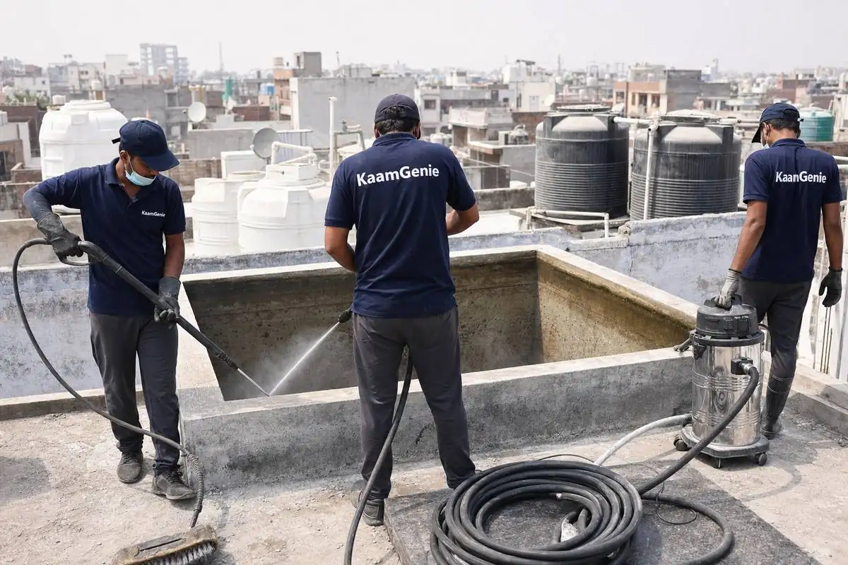 KaamGenie crew cleaning a overhead (rooftop) tank in Tughlakabad, Delhi