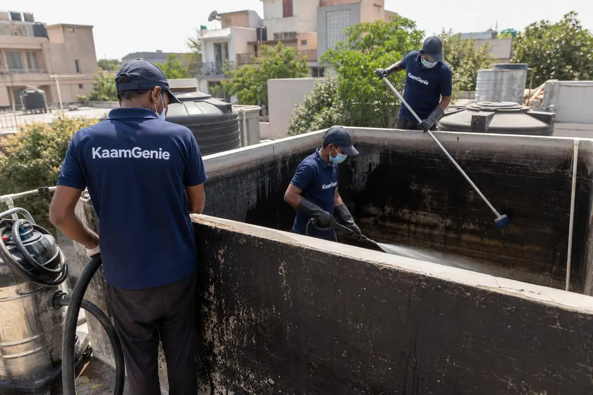 KaamGenie crew cleaning a overhead (rooftop) tank in Vasant Gaon, Delhi