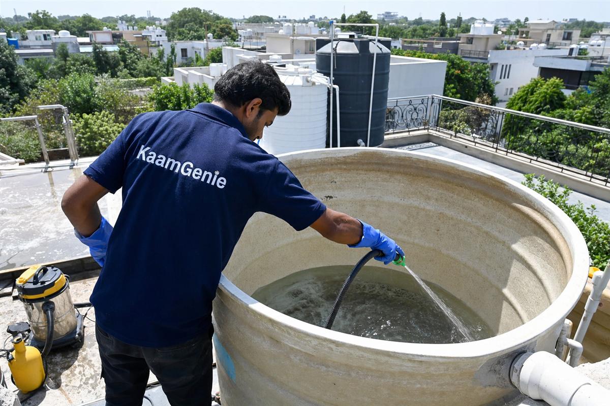 KaamGenie crew cleaning a overhead (rooftop) tank in Vasant Vihar, Delhi