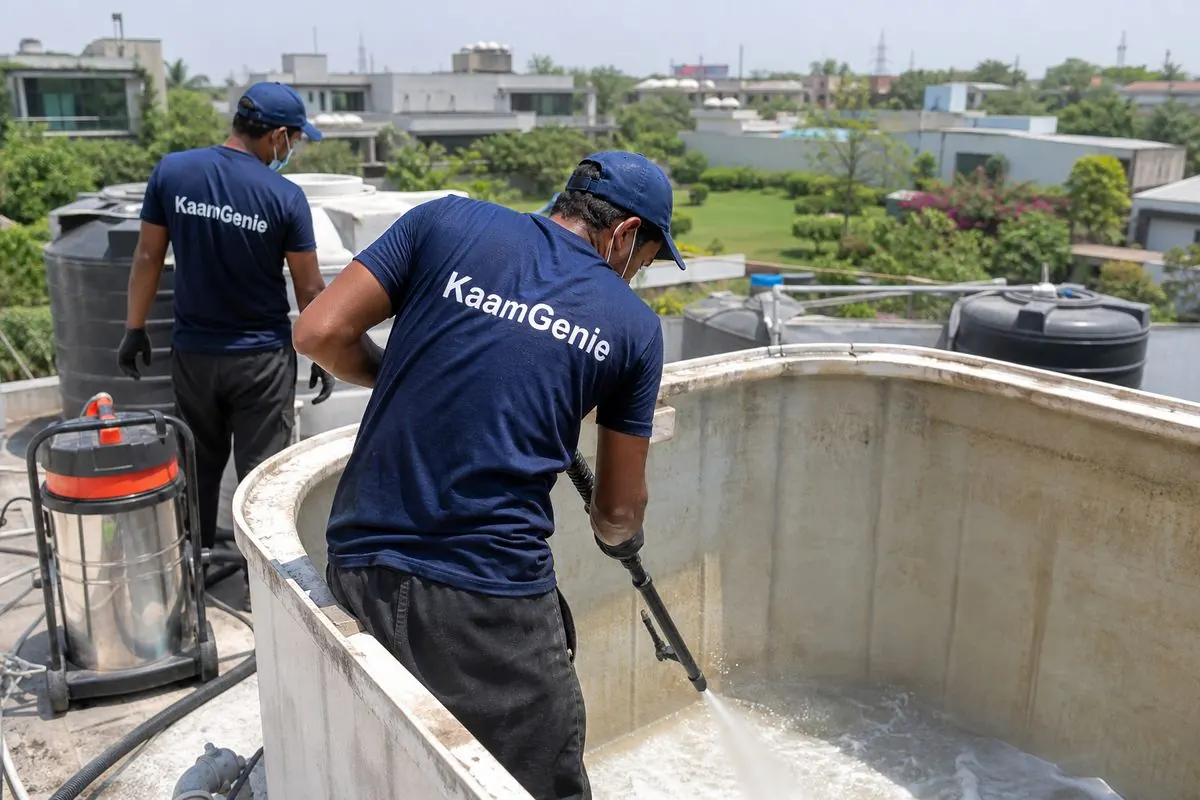KaamGenie crew cleaning a overhead (rooftop) tank in Westend Greens & DLF Farms, Delhi