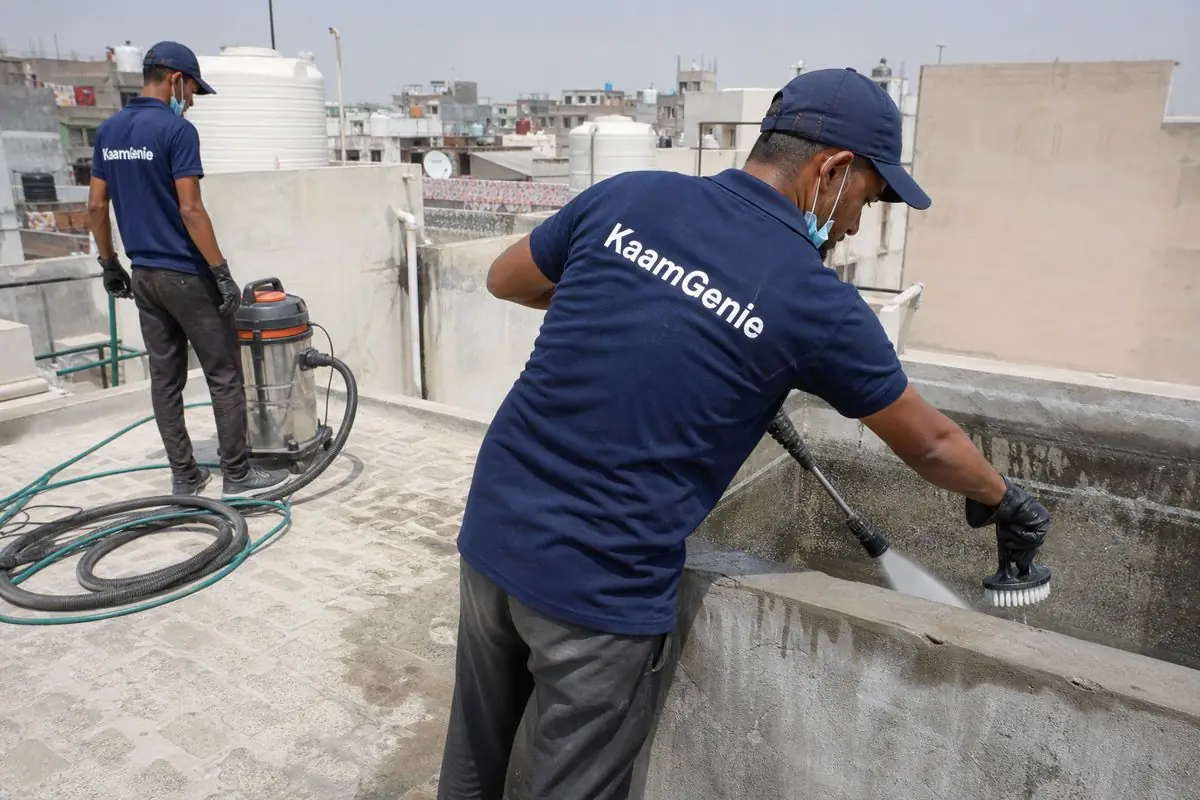 KaamGenie crew cleaning a overhead (rooftop) tank in Yamuna Vihar, Delhi