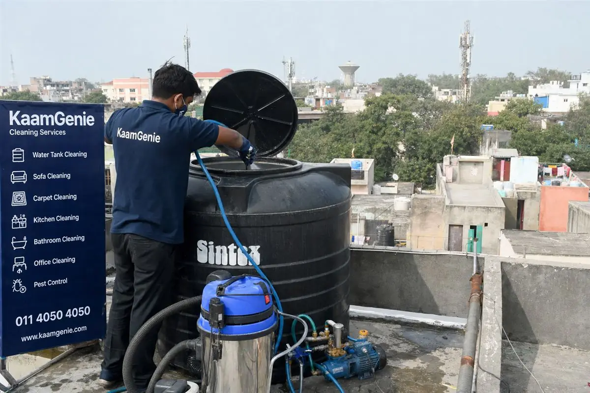 KaamGenie crew cleaning a Sintex / plastic tank in Andrewsganj, Delhi