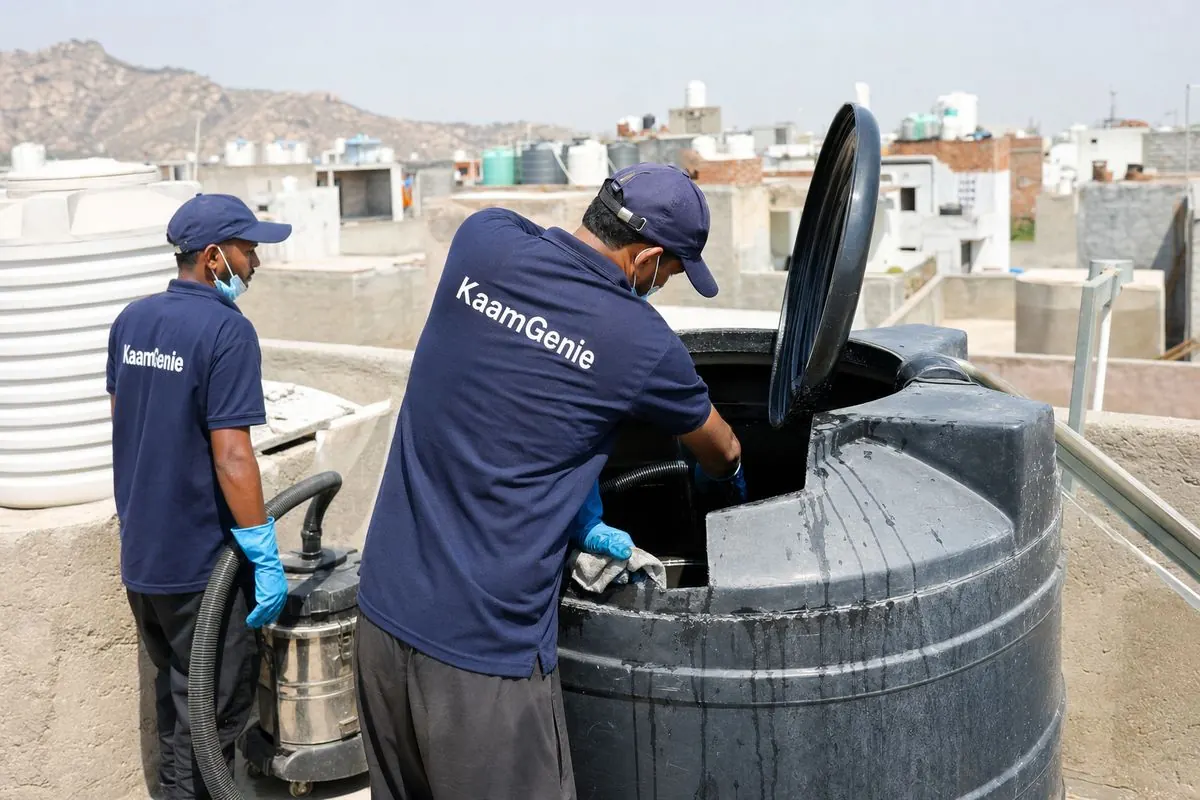 KaamGenie crew cleaning a Sintex / plastic tank in Bhati, Delhi