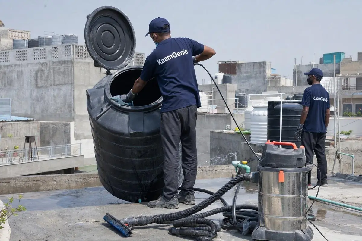 KaamGenie crew cleaning a Sintex / plastic tank in Bijwasan, Delhi