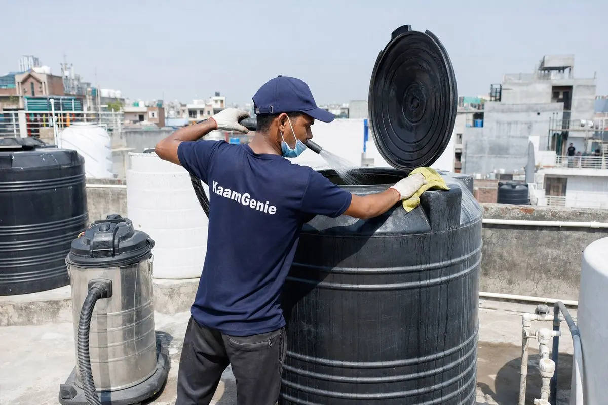 KaamGenie crew cleaning a Sintex / plastic tank in Harkesh Nagar, Delhi