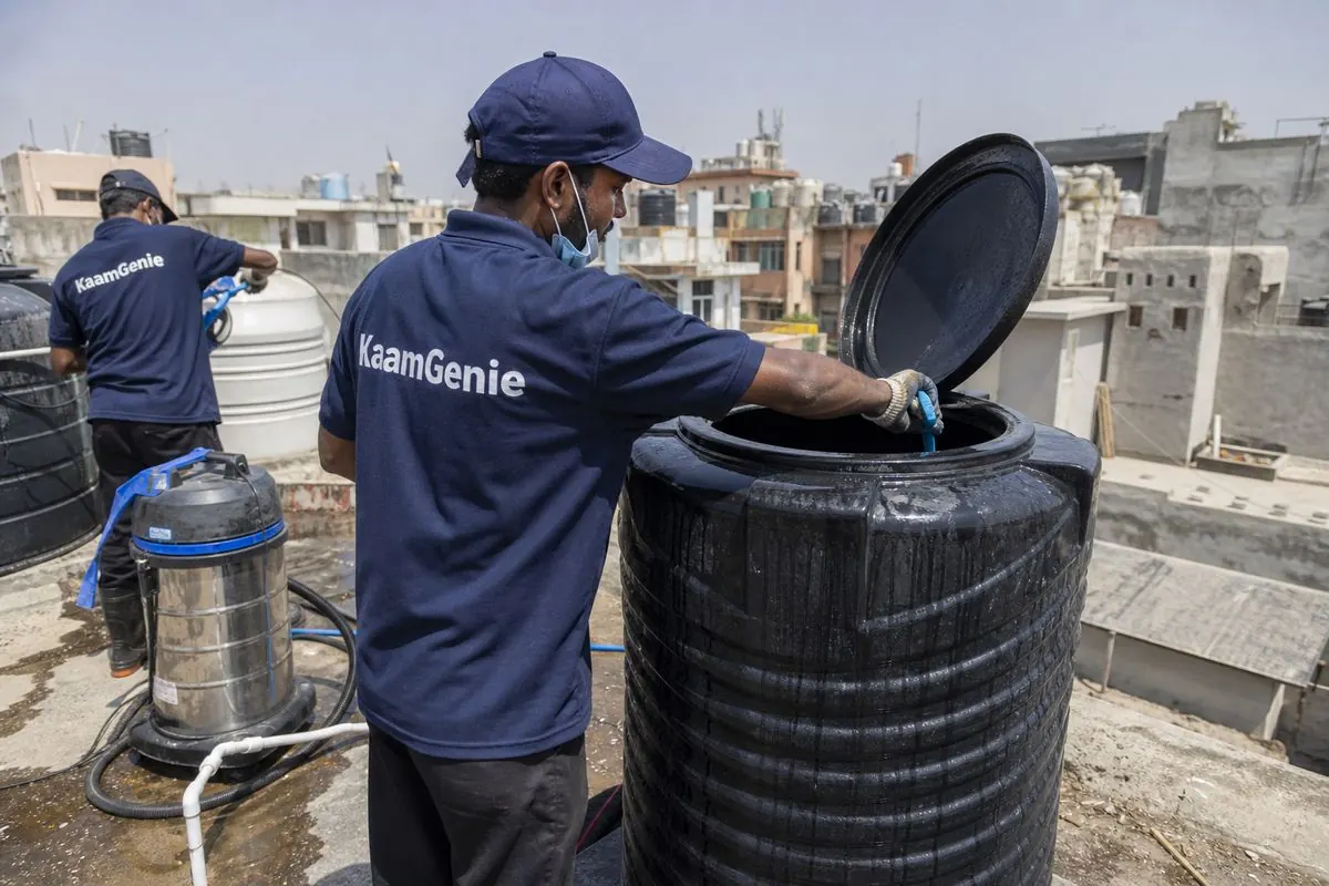 KaamGenie crew cleaning a Sintex / plastic tank in Jangpura, Delhi