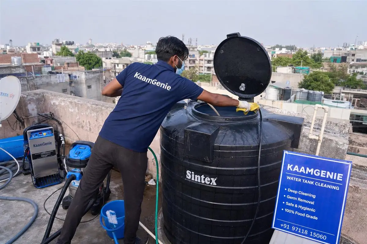 KaamGenie crew cleaning a Sintex / plastic tank in Kalkaji, Delhi