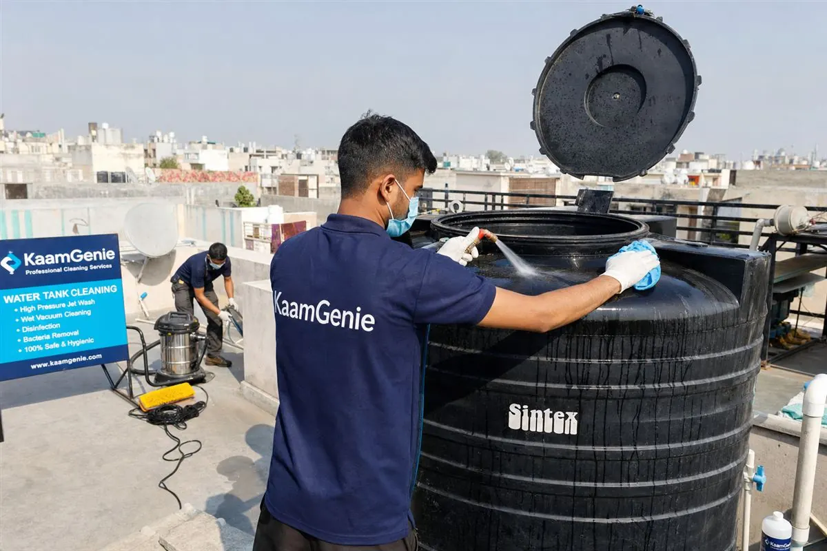 KaamGenie crew cleaning a Sintex / plastic tank in Khirki Extension, Delhi