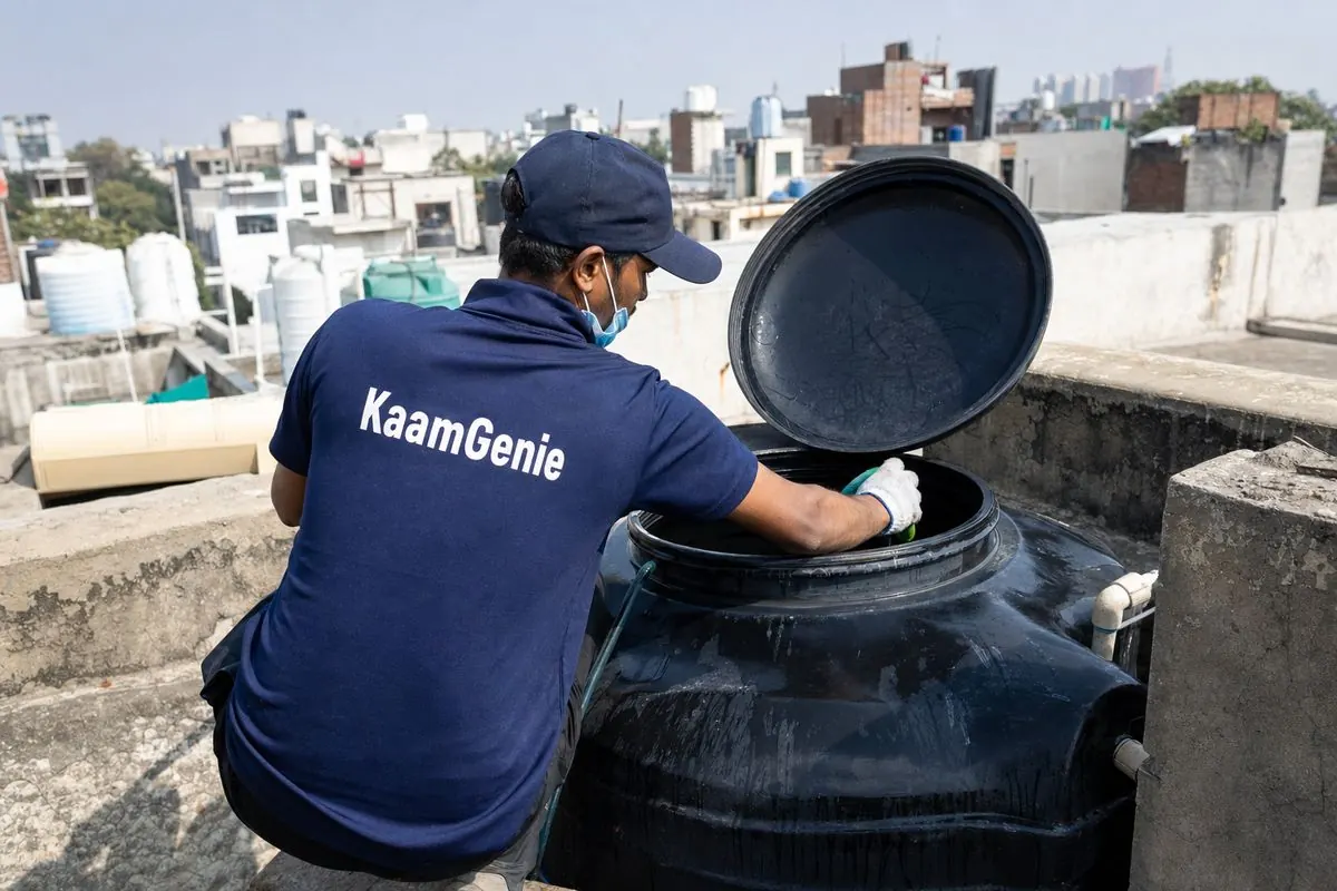KaamGenie crew cleaning a Sintex / plastic tank in Khirki Village, Delhi