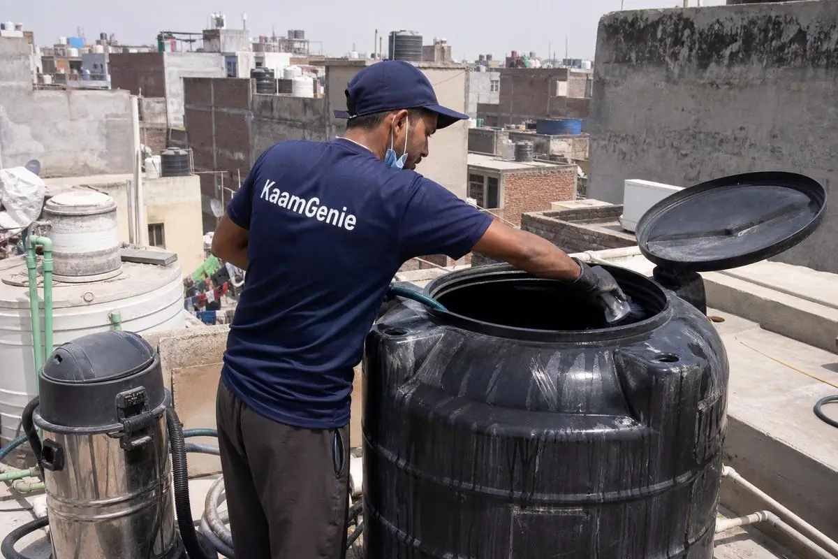 KaamGenie crew cleaning a Sintex / plastic tank in Kirari Suleman Nagar, Delhi