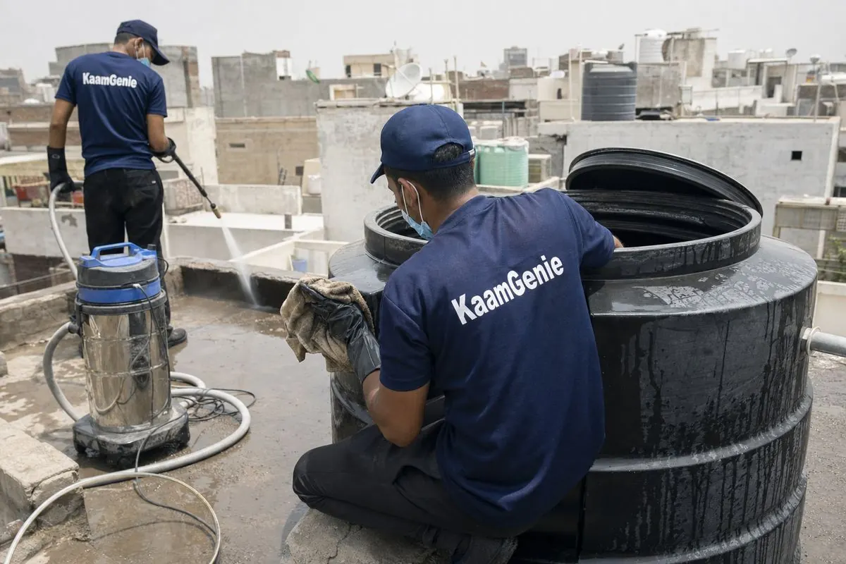 KaamGenie crew cleaning a Sintex / plastic tank in Lado Sarai, Delhi