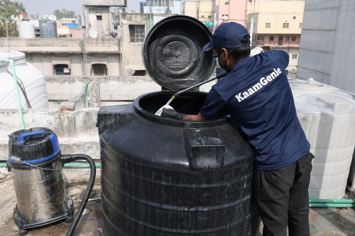 KaamGenie crew cleaning a Sintex / plastic tank in Lodhi Colony, Delhi