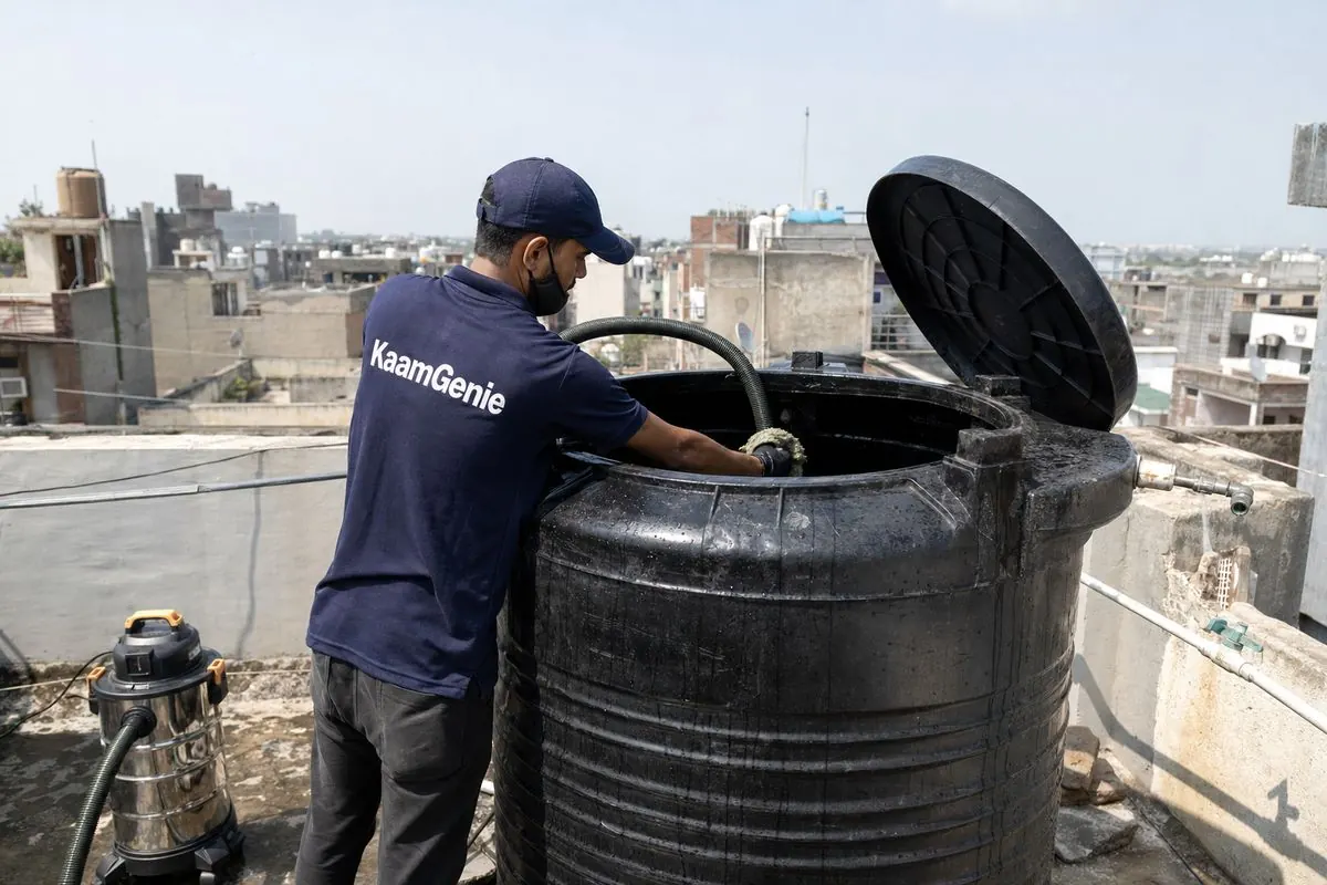 KaamGenie crew cleaning a Sintex / plastic tank in Madanpur Khadar, Delhi