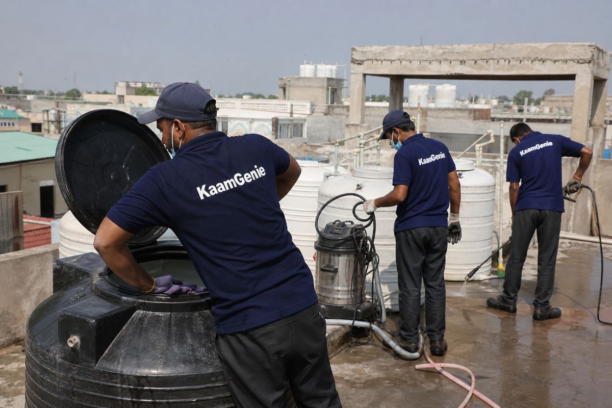 KaamGenie crew cleaning a Sintex / plastic tank in Mangolpuri, Delhi