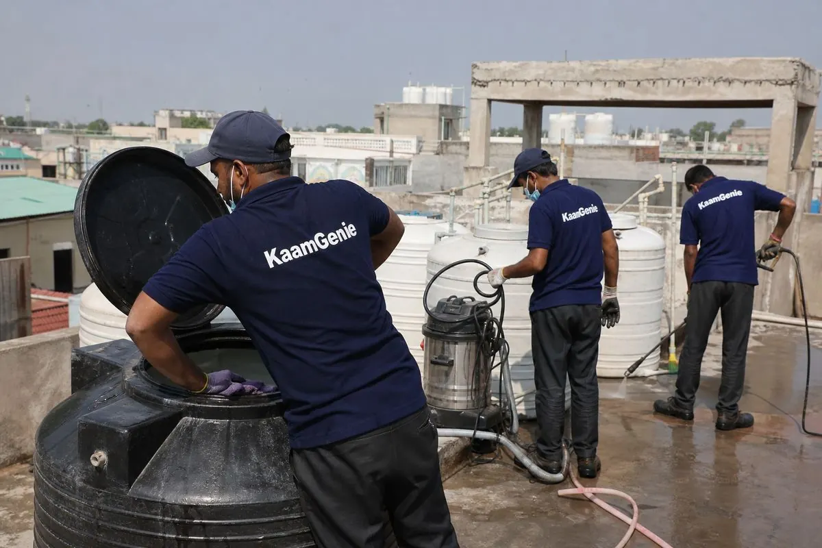 KaamGenie crew cleaning a Sintex / plastic tank in Mangolpuri, Delhi