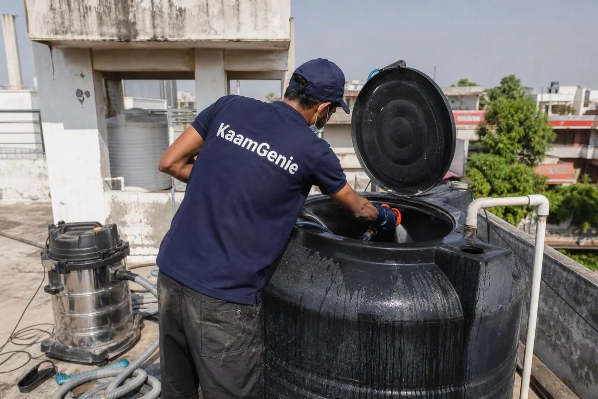 KaamGenie crew cleaning a Sintex / plastic tank in Model Town, Delhi