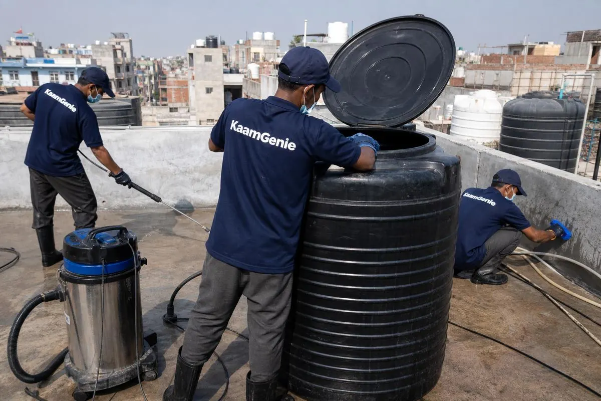 KaamGenie crew cleaning a Sintex / plastic tank in Nand Nagri (C Block), Delhi