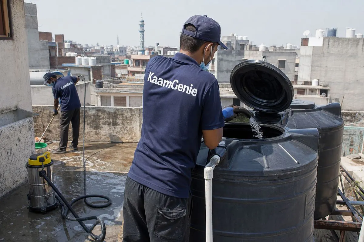 KaamGenie crew cleaning a Sintex / plastic tank in Noor Nagar, Delhi
