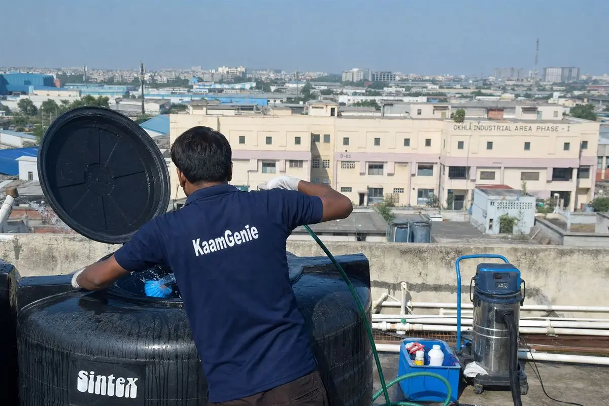 KaamGenie crew cleaning a Sintex / plastic tank in Okhla Phase 1, Delhi