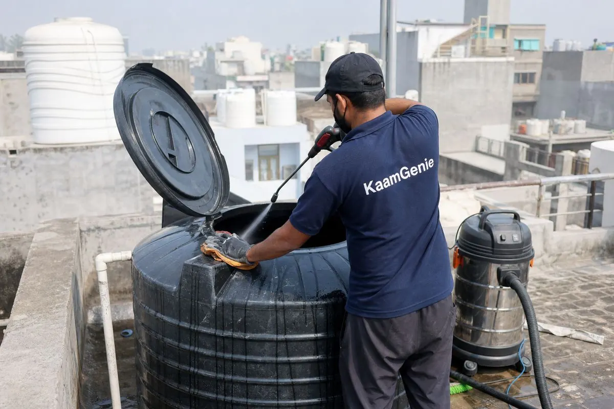 KaamGenie crew cleaning a Sintex / plastic tank in Ramesh Nagar, Delhi