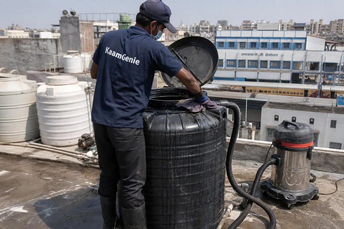 KaamGenie crew cleaning a Sintex / plastic tank in Sarai Rohilla, Delhi