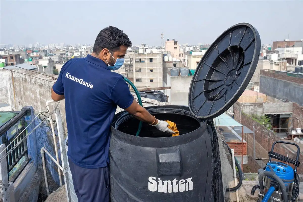 KaamGenie crew cleaning a Sintex / plastic tank in Shahpur Jat, Delhi