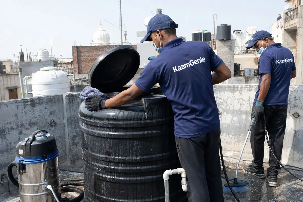 KaamGenie crew cleaning a Sintex / plastic tank in Tilak Nagar, Delhi